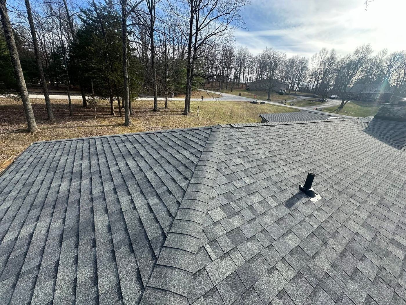 Completed residential shingle roof with clean ridge line