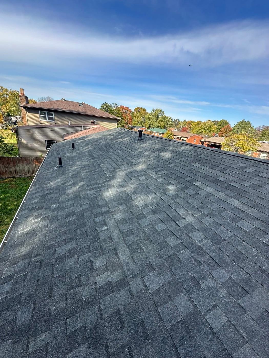 Residential roofing project with finished shingles and roof vents