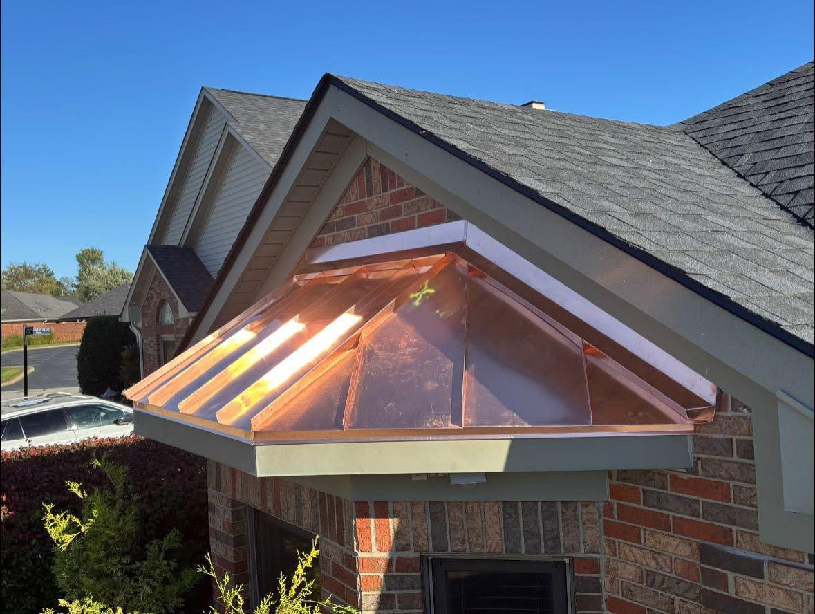 Copper awning detail on brick home exterior