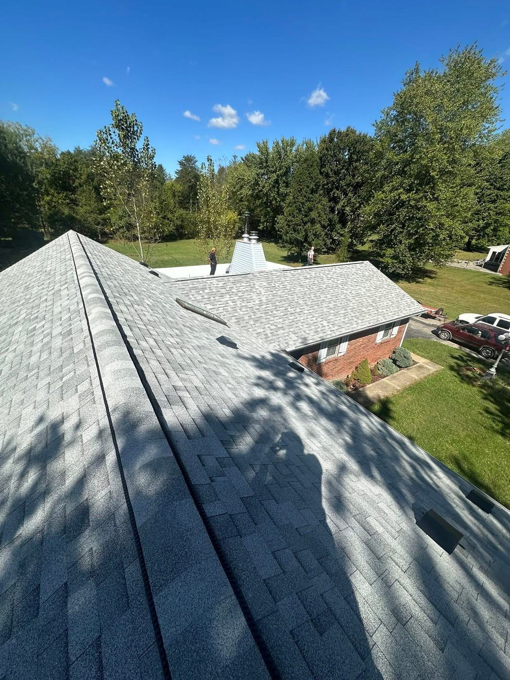 Residential roof replacement with chimney and clean shingle lines