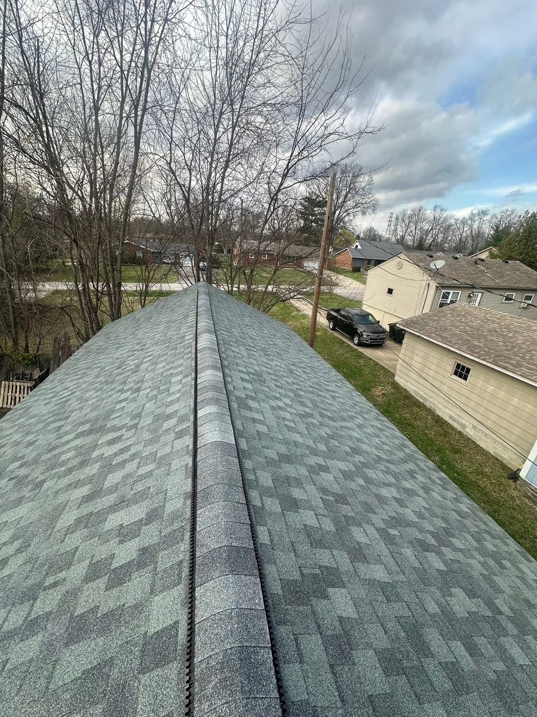 Finished residential roof ridge line and shingle pattern