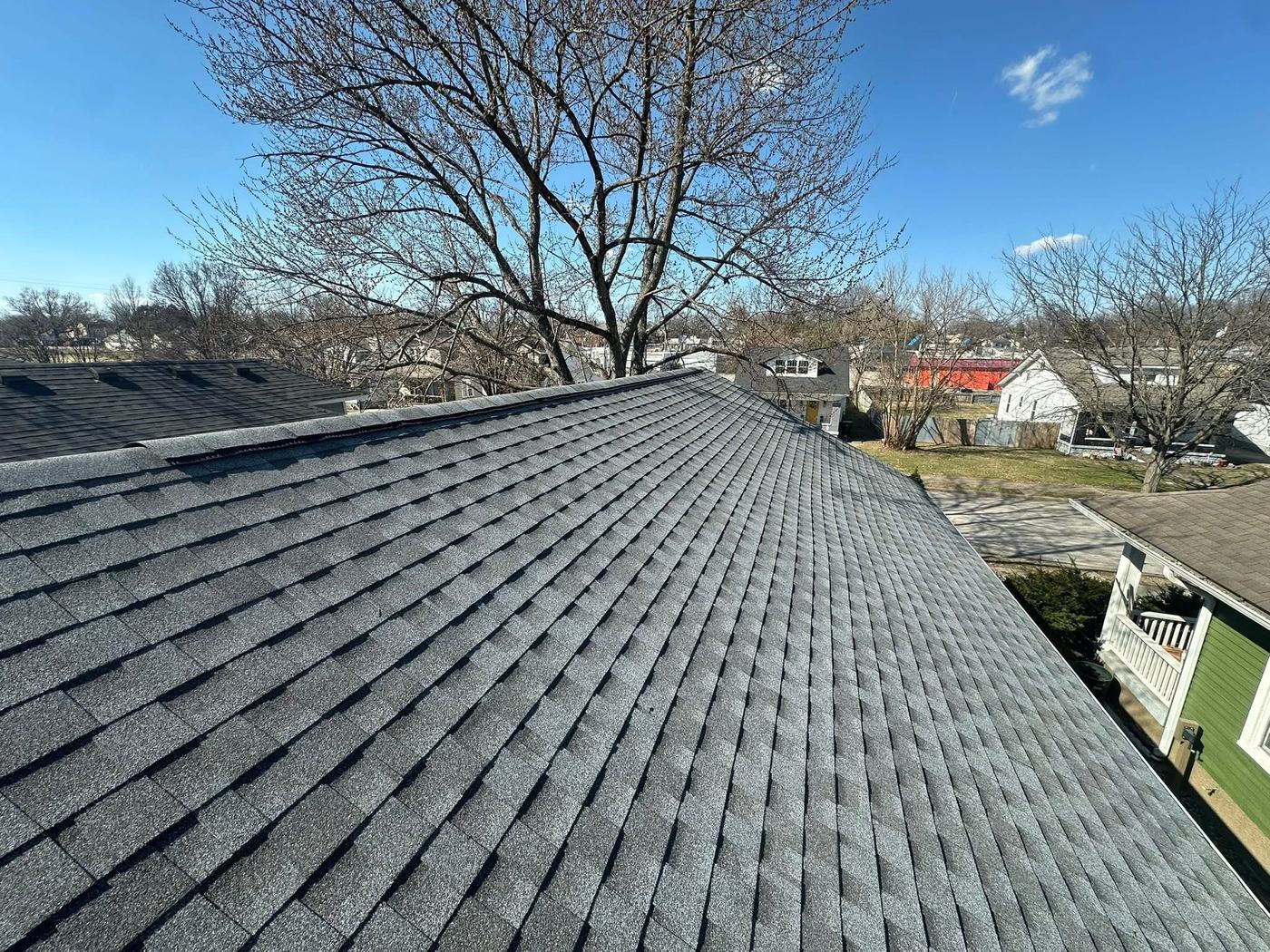 Completed shingle roof line photographed in bright daylight