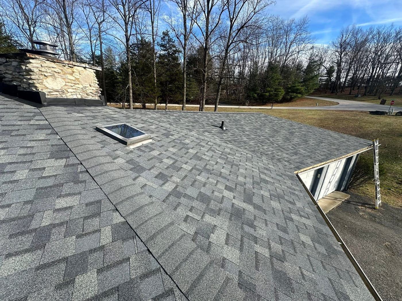 Residential roof project with new shingles and roof penetrations