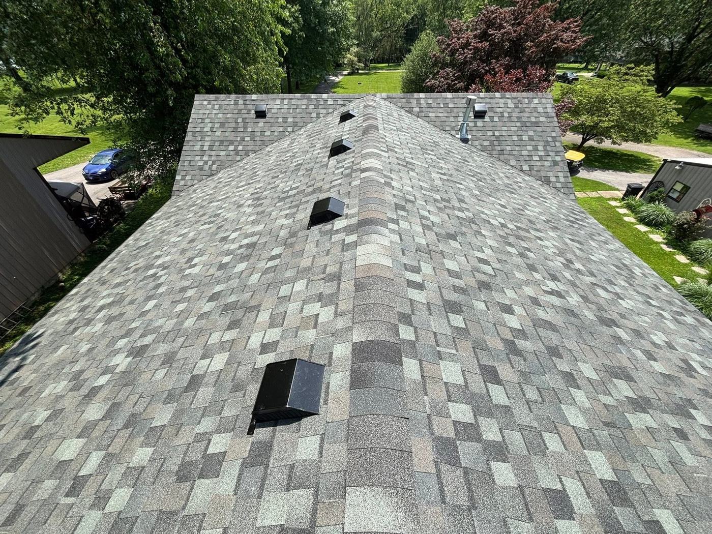 New shingle roof around brick chimney and home exterior