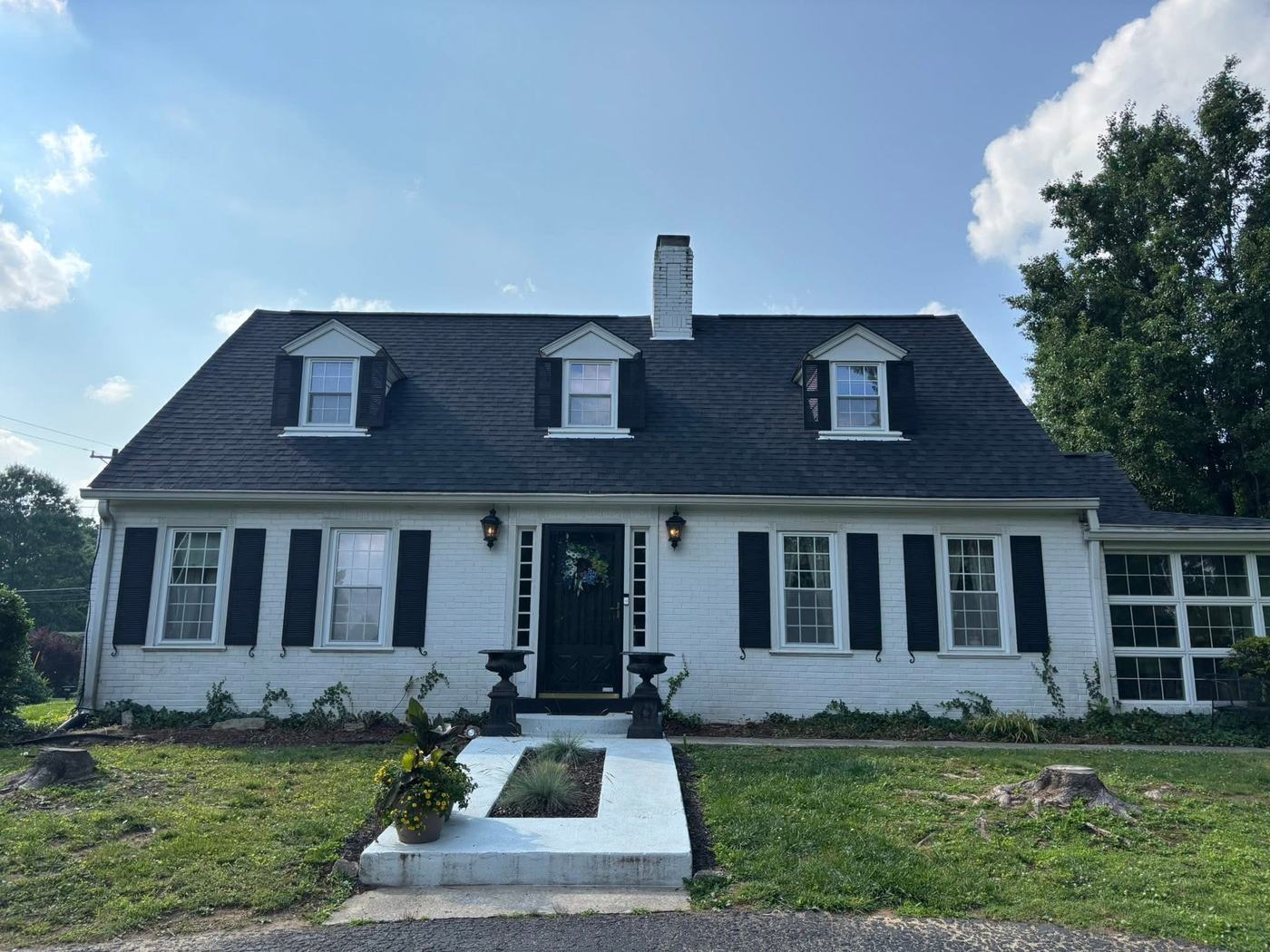 Completed residential roof on white home exterior