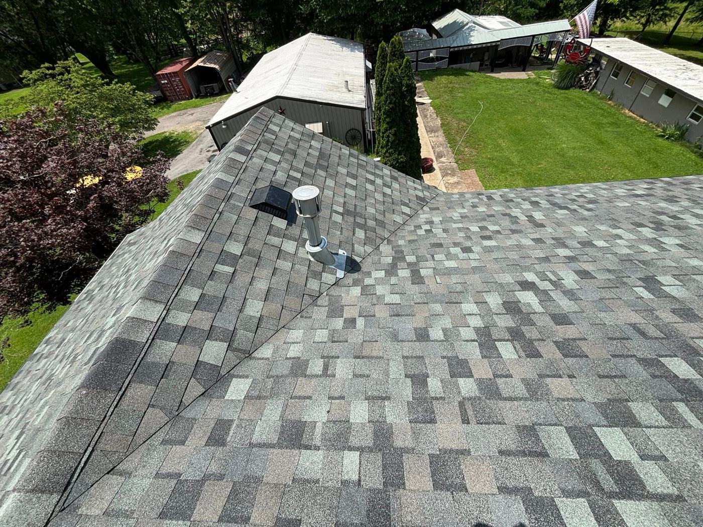 Roof replacement project with new shingles photographed from above